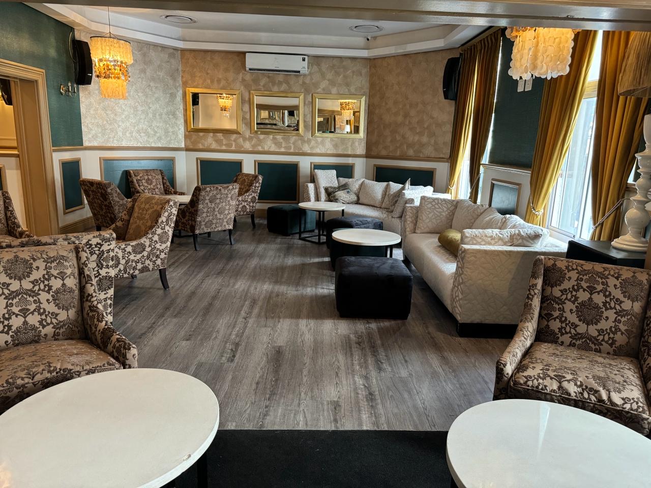 Brown couches with white tables in lounge area