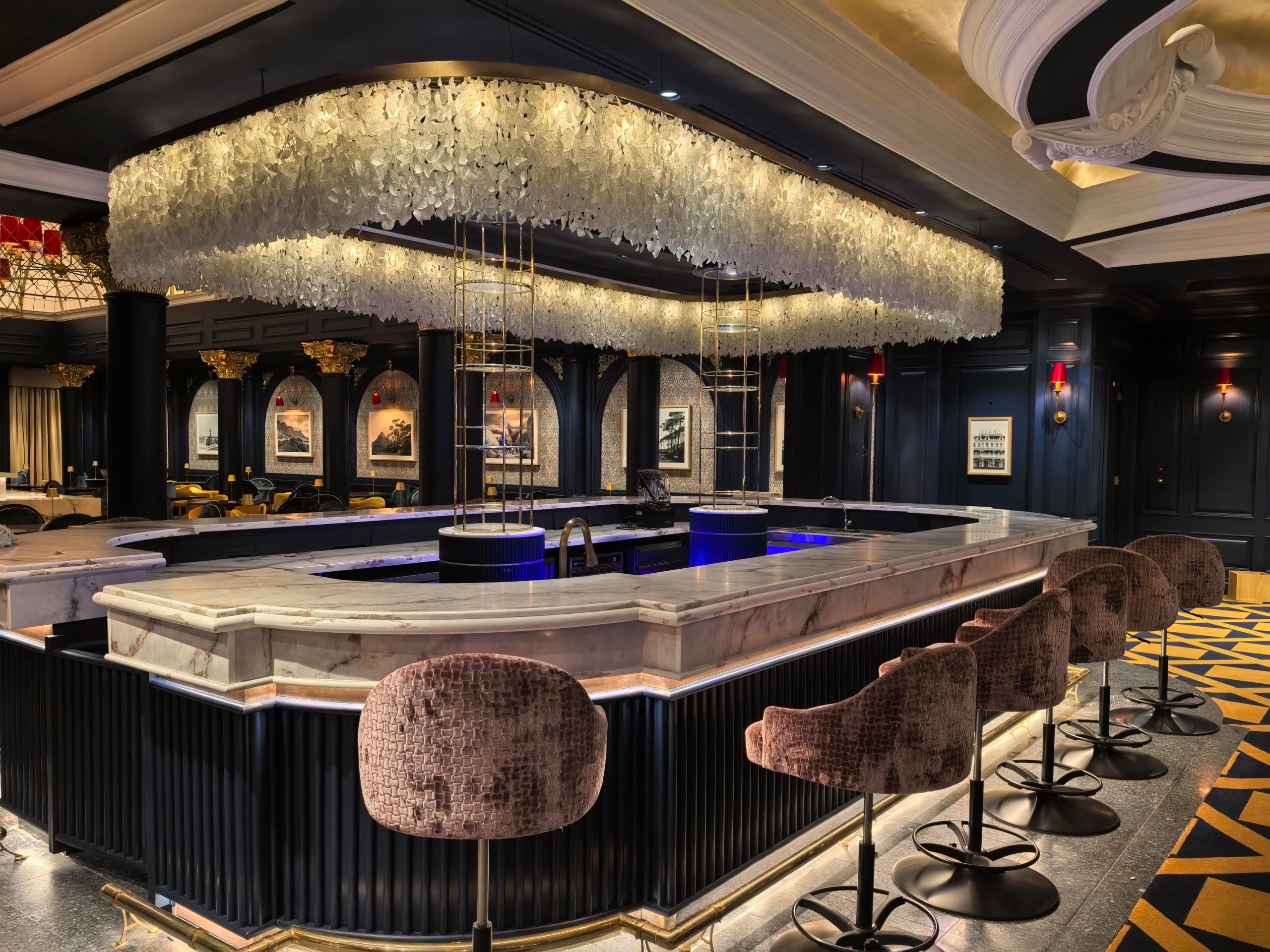 Suede bar stools at bar with marble countertop